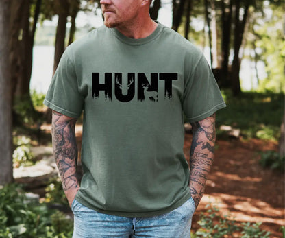 Hunt graphic t-shit, with deer and trees shadowed in the letters. Unisex green tee with black letters. availble in Small to 3XL shop at Auds & Ends Boutique
