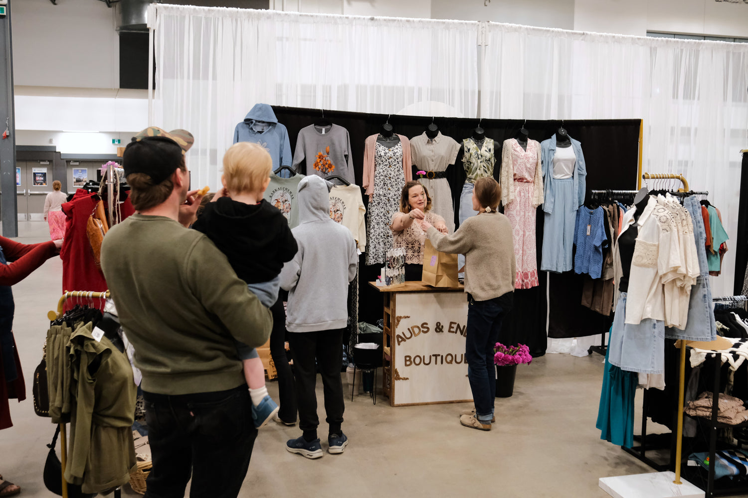 Audrey helping a customer at an Auds & Ends Boutique market booth
