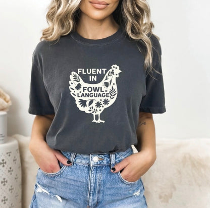 Pepper colour graphic  t-shirt with a cream floral chicken, that says Fluent in Fowl Language.  Auds & Ends Boutique